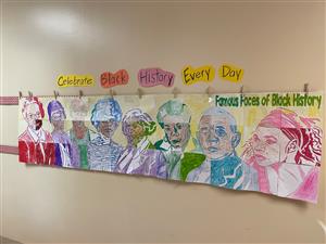 Photo shows colorful mural, created by students, displaying prominent African Americans throughout history.